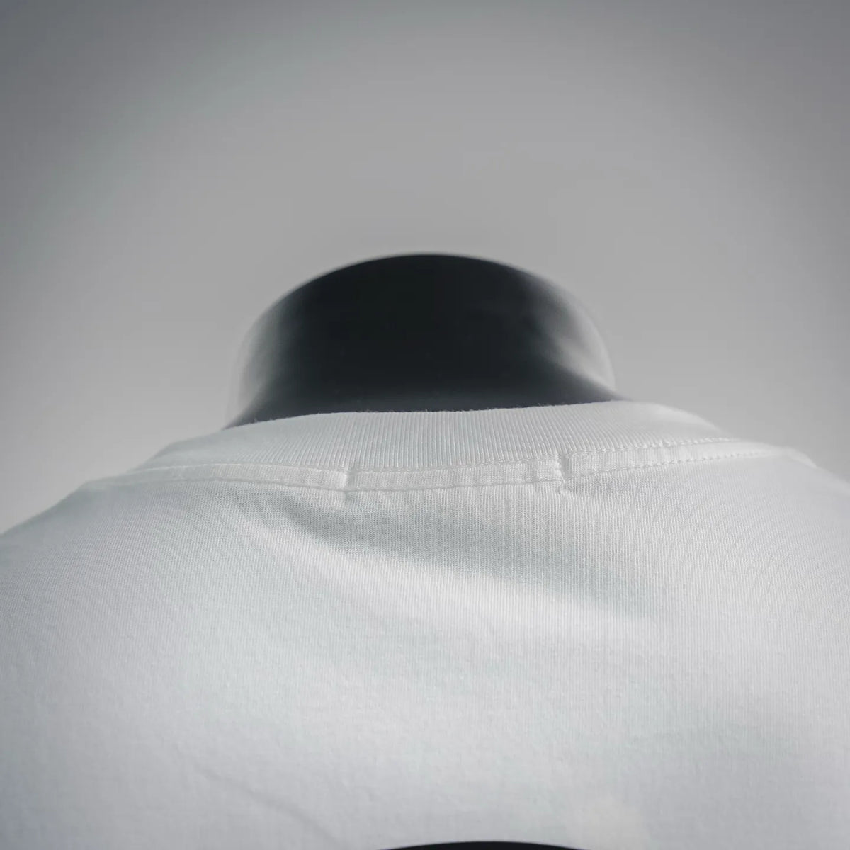 White T-shirt back collar close-up with smooth crew neck seam