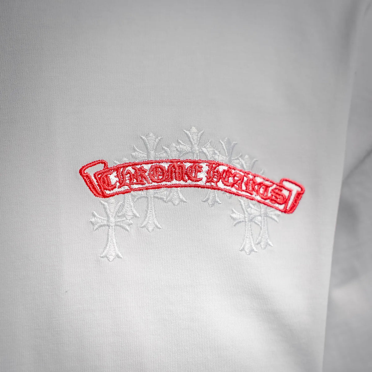 White T-shirt with embroidered red-and-white front logo banner