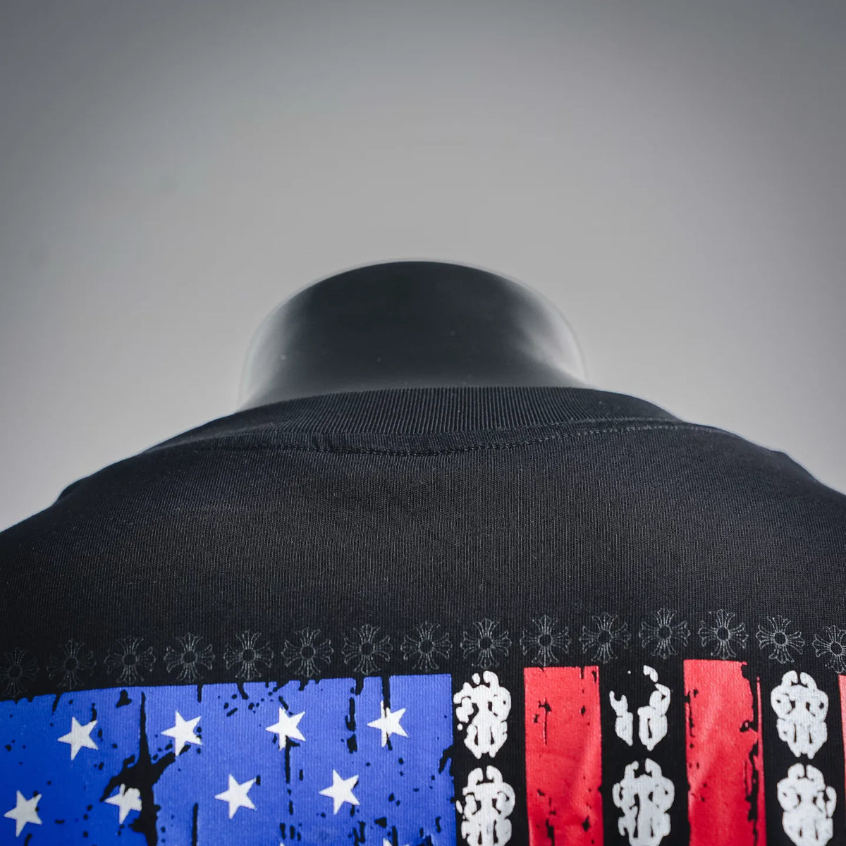 Black T-shirt back collar with multicolor American flag graphic panel detail