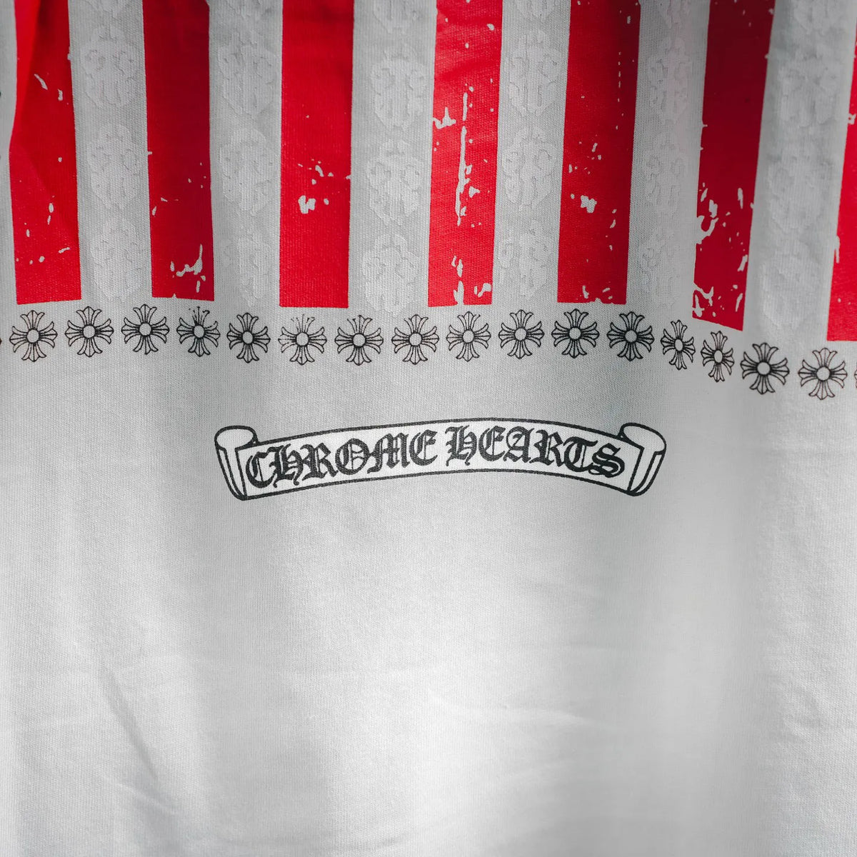 White T-shirt with red and white vertical stripes and decorative flower row