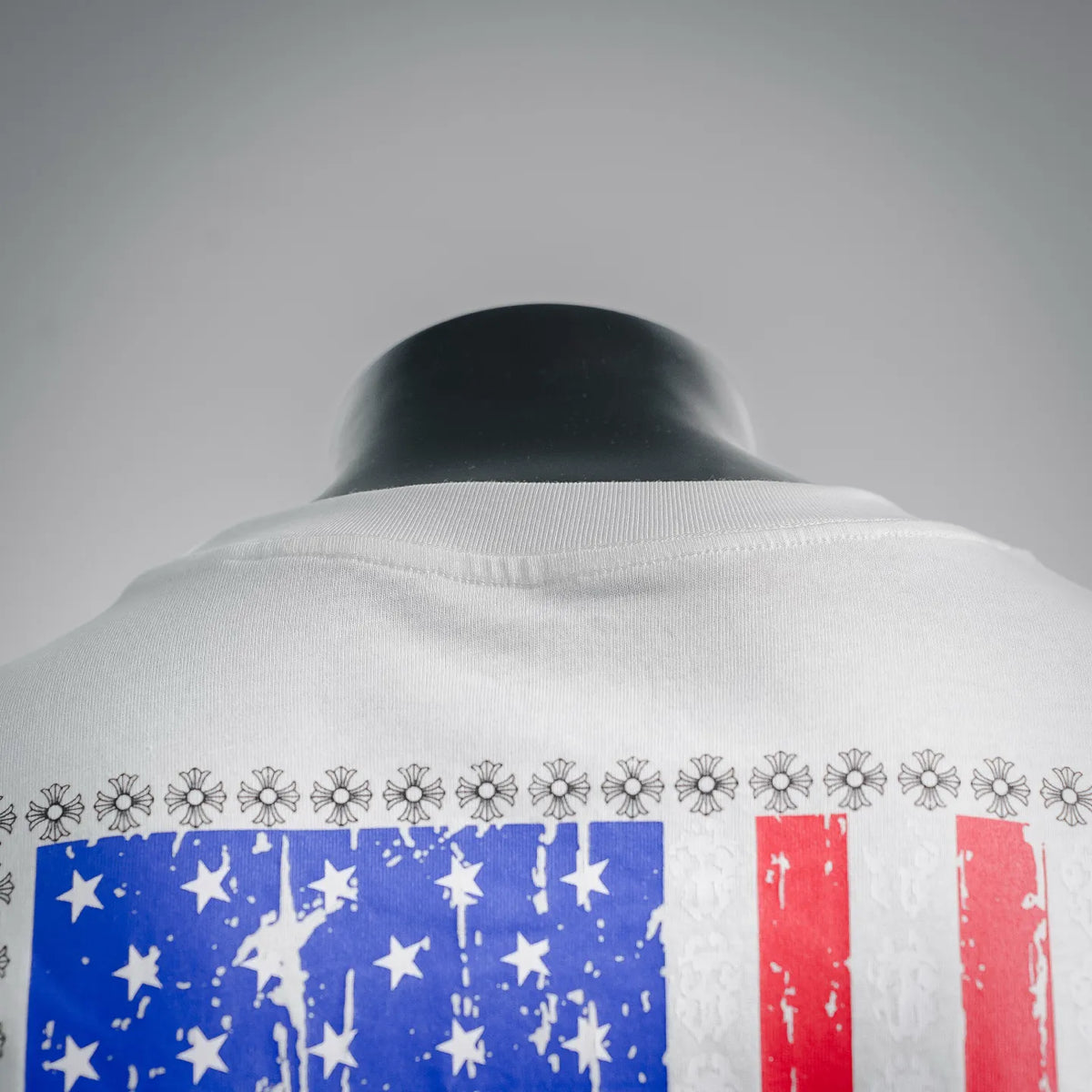 White T-shirt back neckline with American flag graphic across upper back