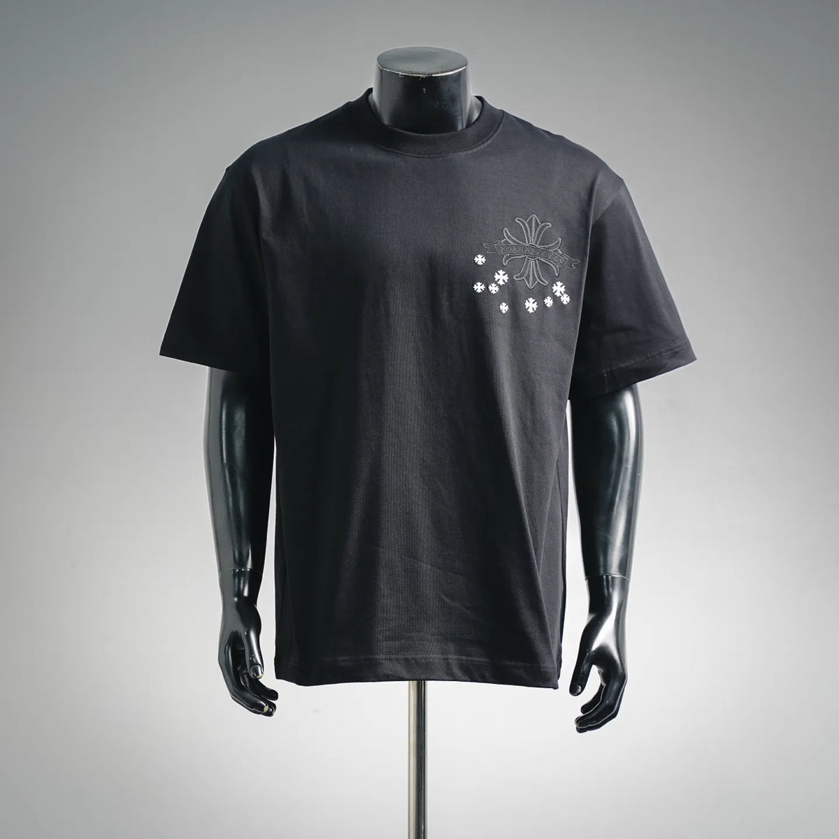 Black crew-neck T-shirt with small white snowflake-style logo on the chest