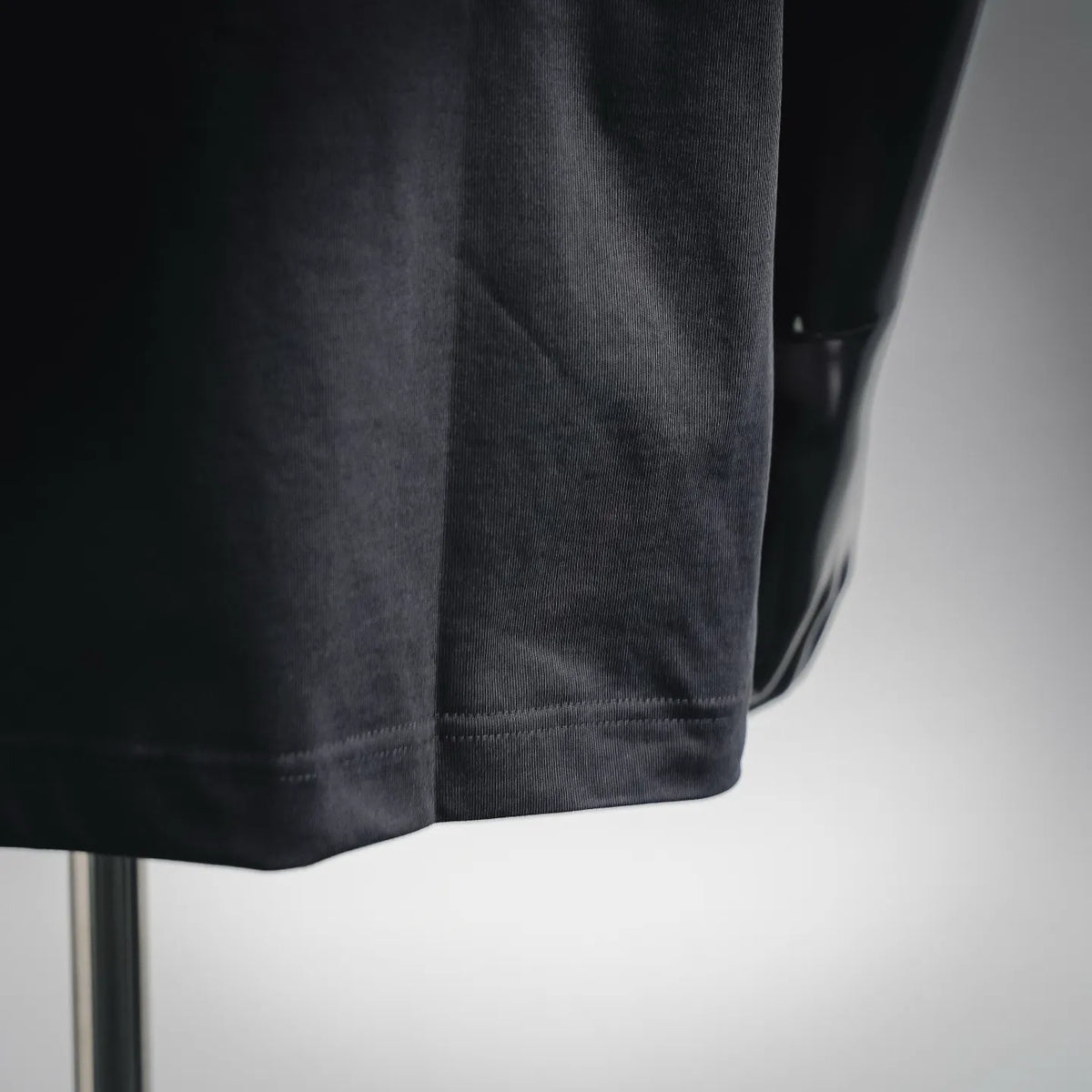 Black T-shirt sleeve cuff and hem with visible stitching