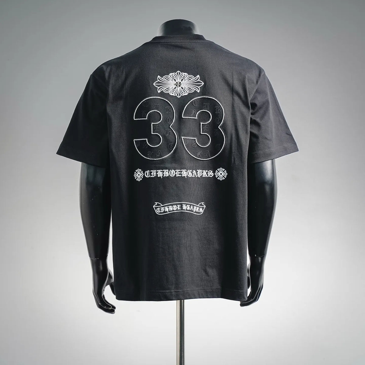 Black short-sleeve graphic T-shirt with large white “33” on the back.