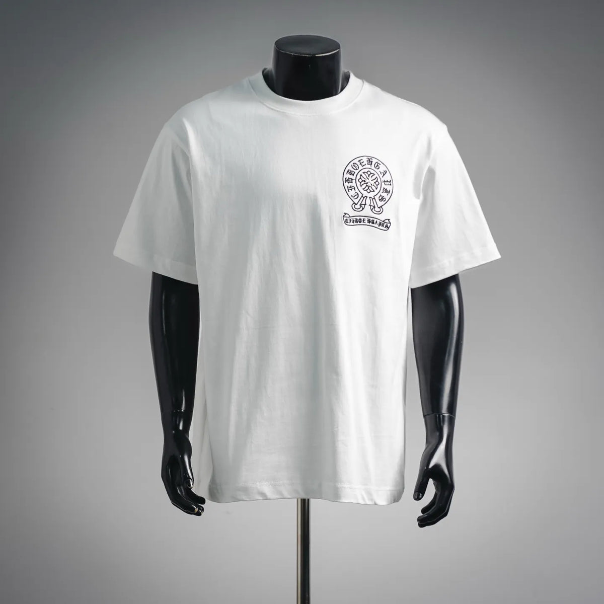 White crew-neck T-shirt on mannequin, small chest crest logo print