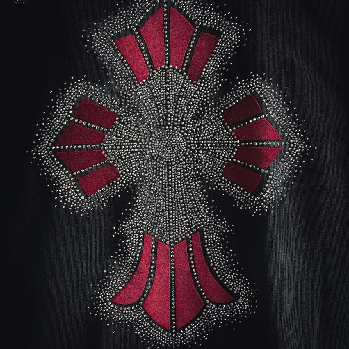 Rhinestone emblem with red fan segments on black T-shirt