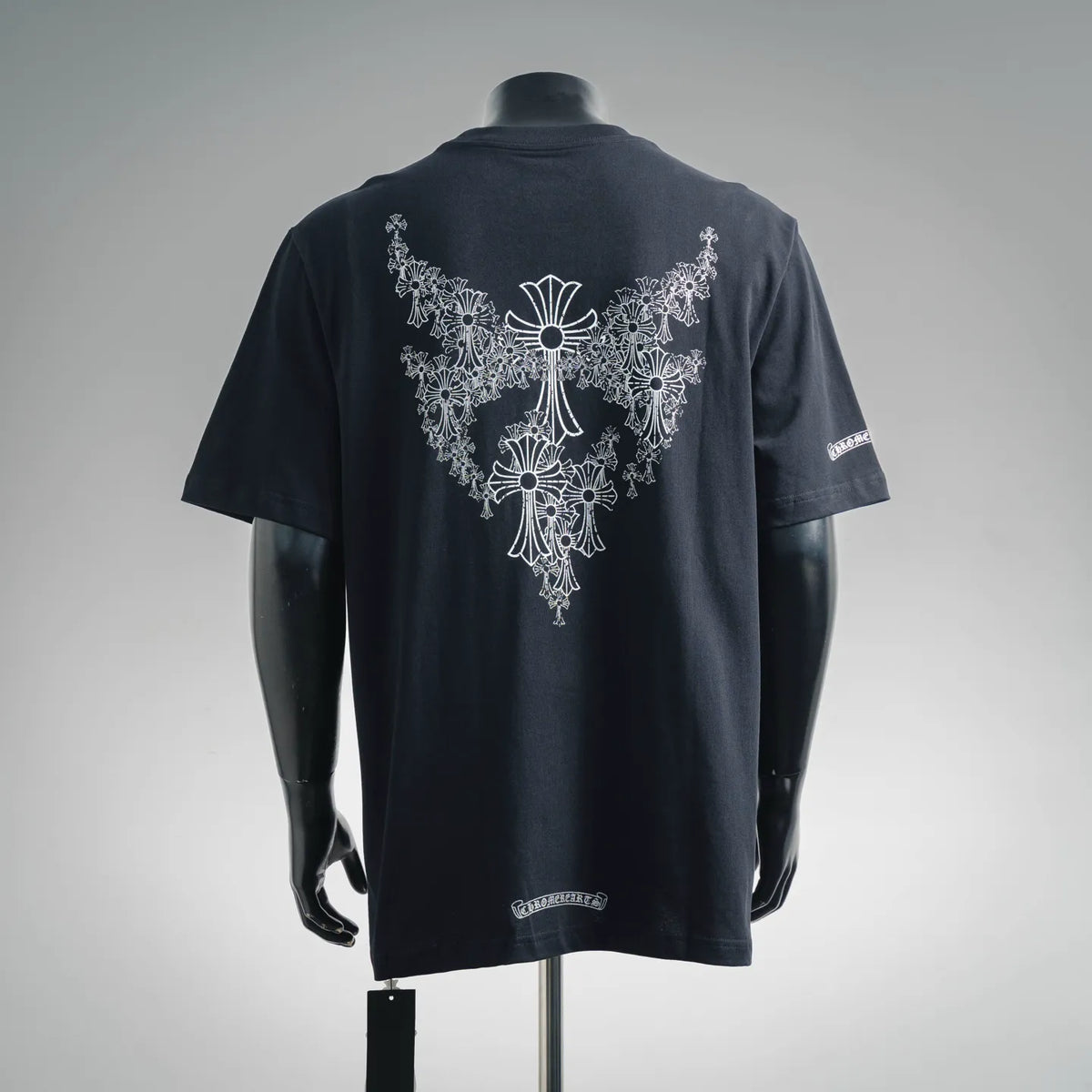 Black short-sleeve T-shirt with large white ornate cross graphic on the back and sleeve patch