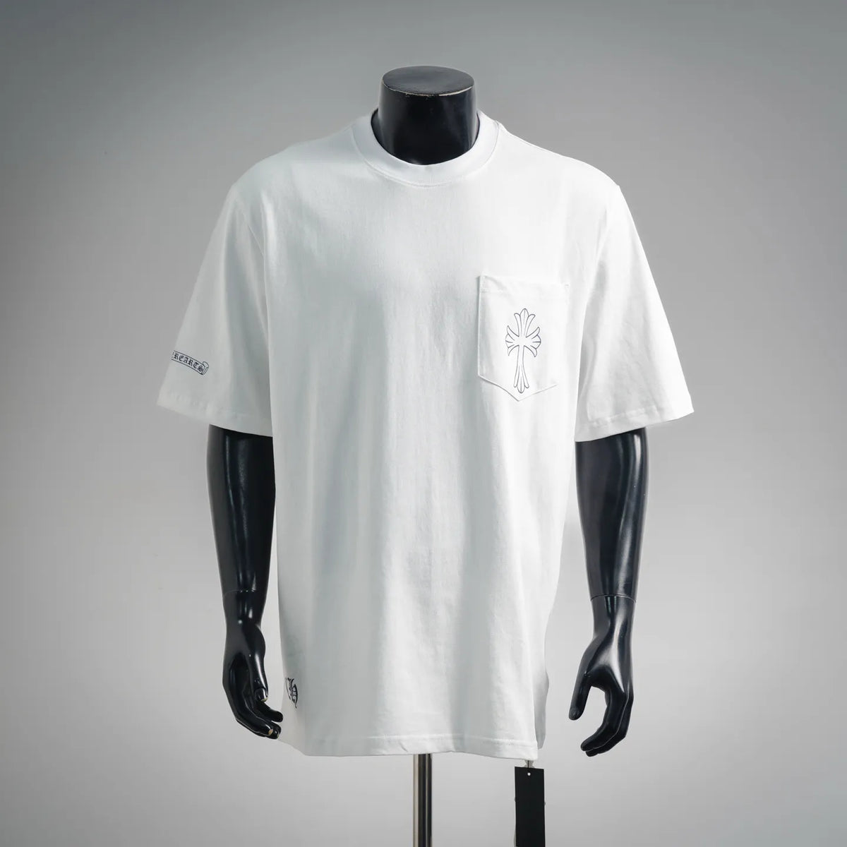 White short-sleeve T-shirt with small chest graphic and sleeve logo detail