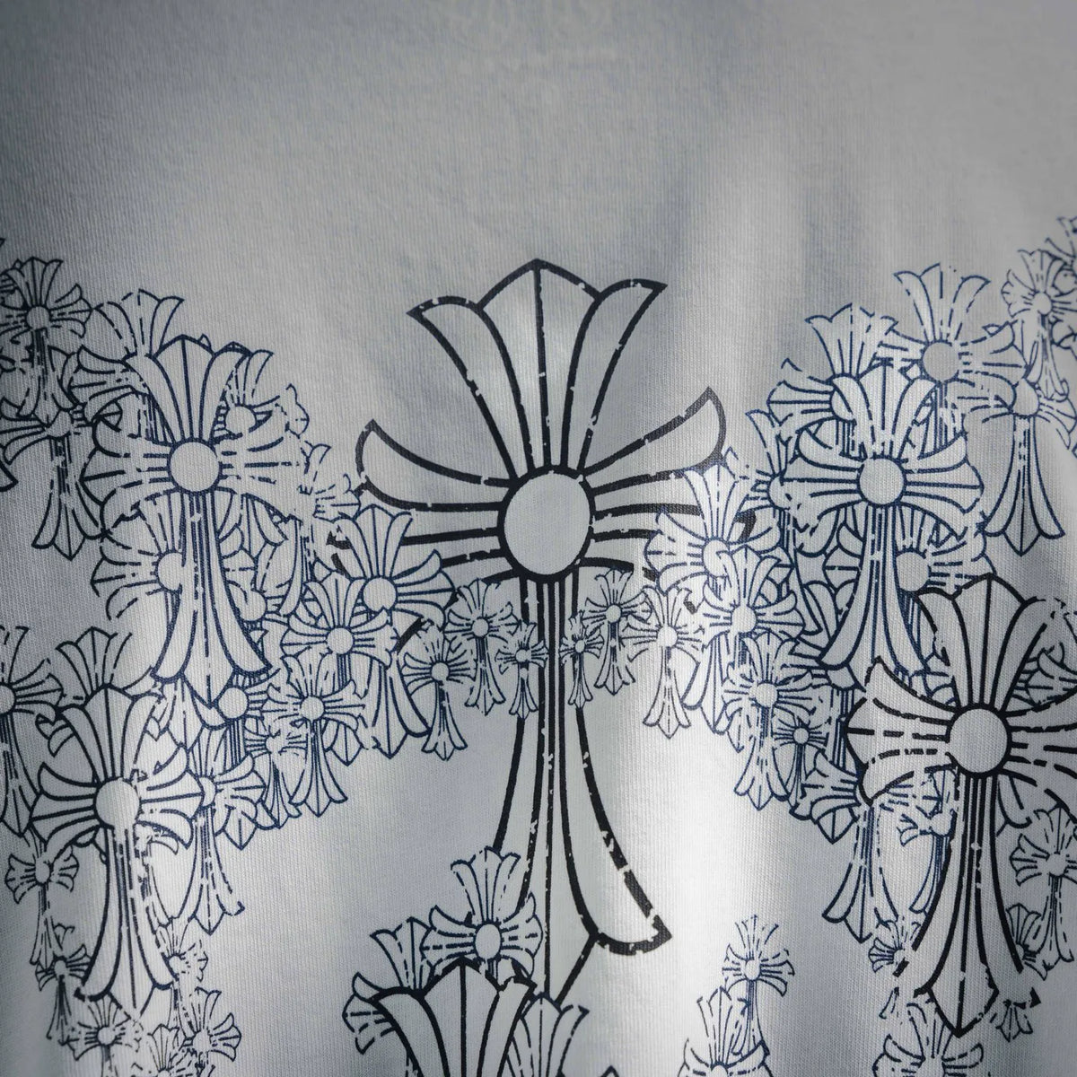 Close-up of blue-gray floral graphic on the back of a white T-shirt