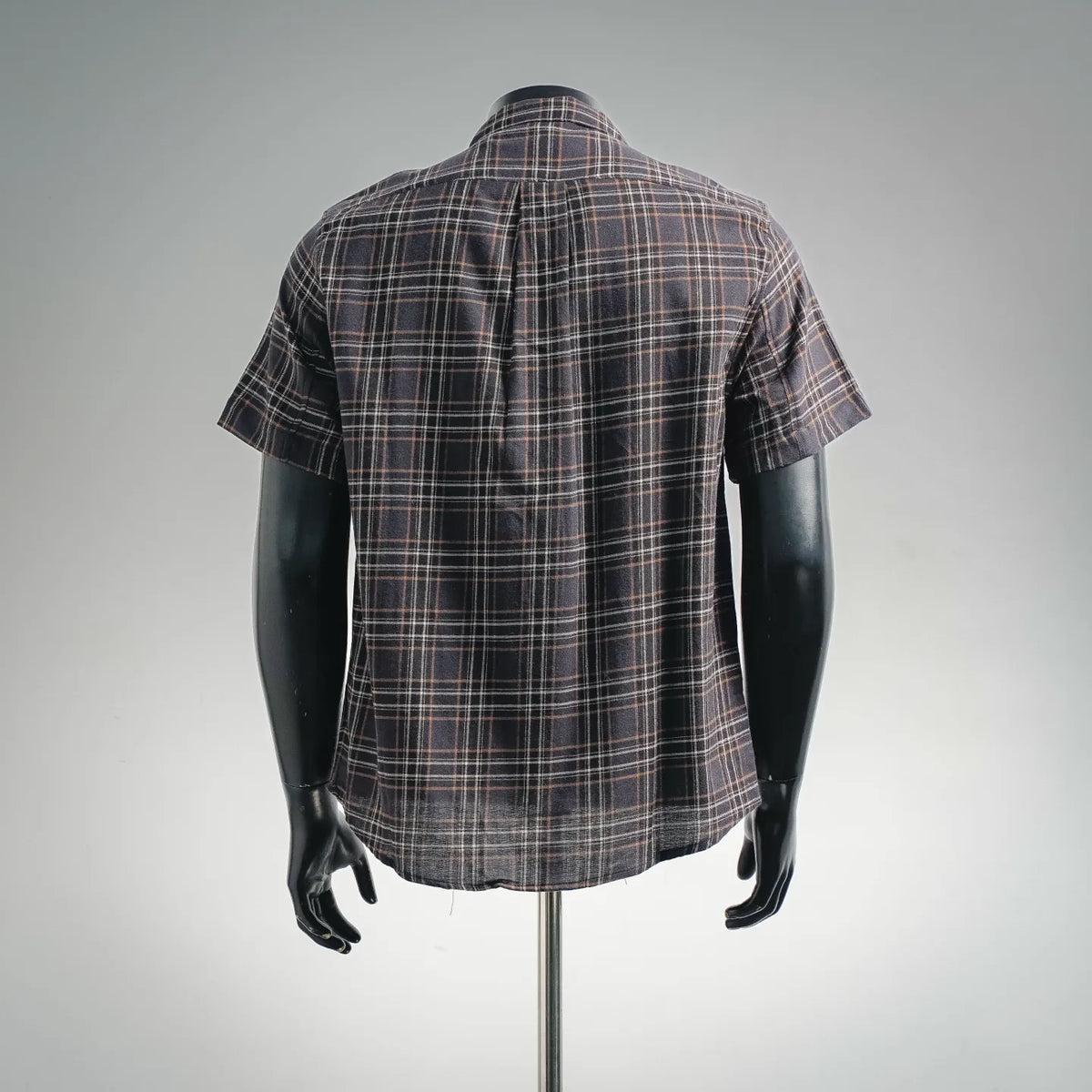 Plaid short-sleeve zip shirt back view on mannequin, dark check pattern