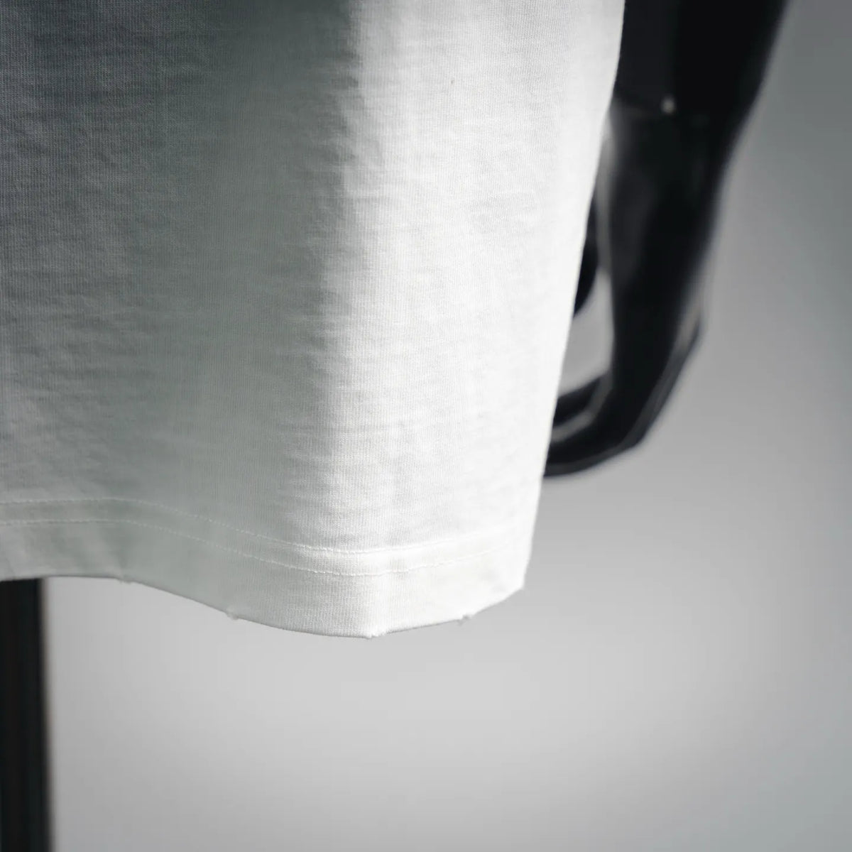 White T-shirt hem and short sleeve edge with smooth fabric texture