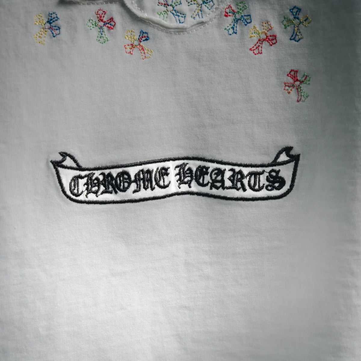 White T-shirt chest graphic embroidery with stylized black outlined text