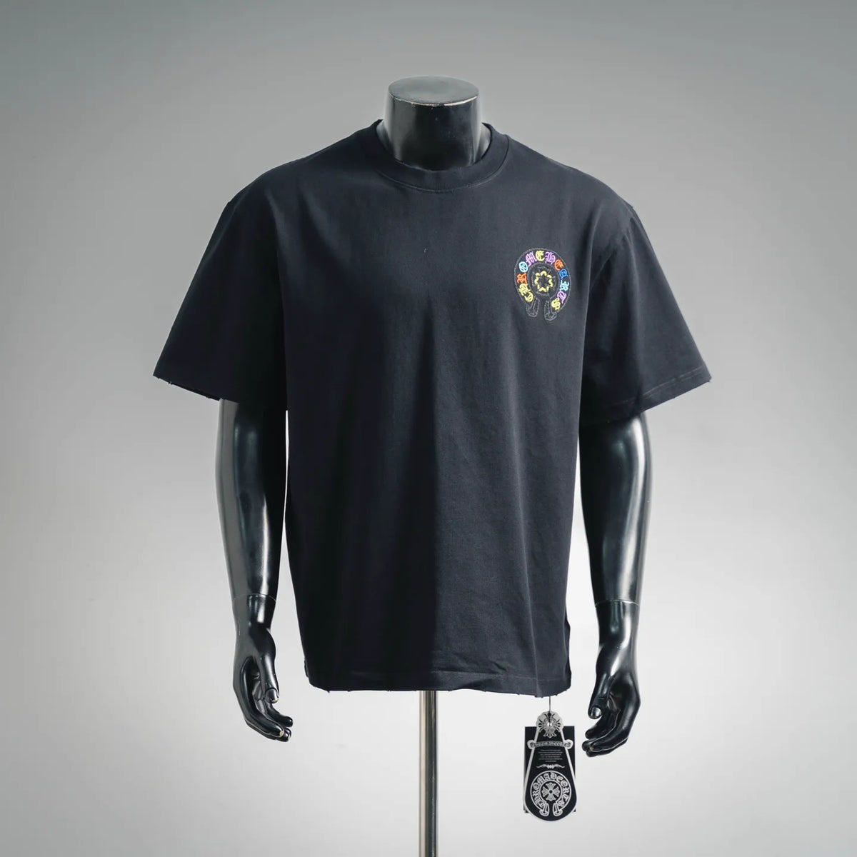 Black crewneck short-sleeve T-shirt with colorful circular chest graphic.
