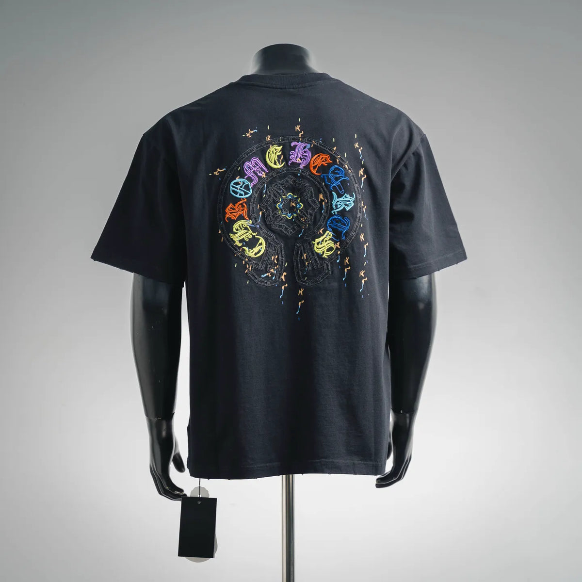 Black crewneck short-sleeve T-shirt with large colorful circular back graphic.