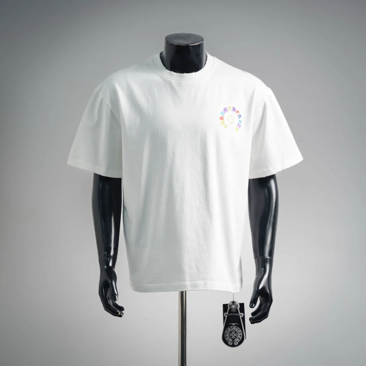 White short-sleeve T-shirt with small circular multicolor embroidered chest graphic