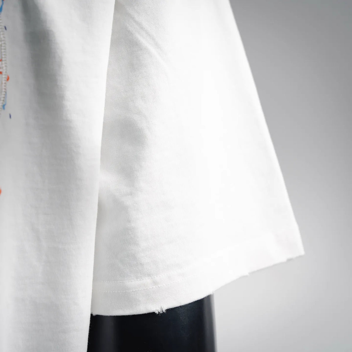 White T-shirt straight hem with stitched edge and slight wrinkle texture
