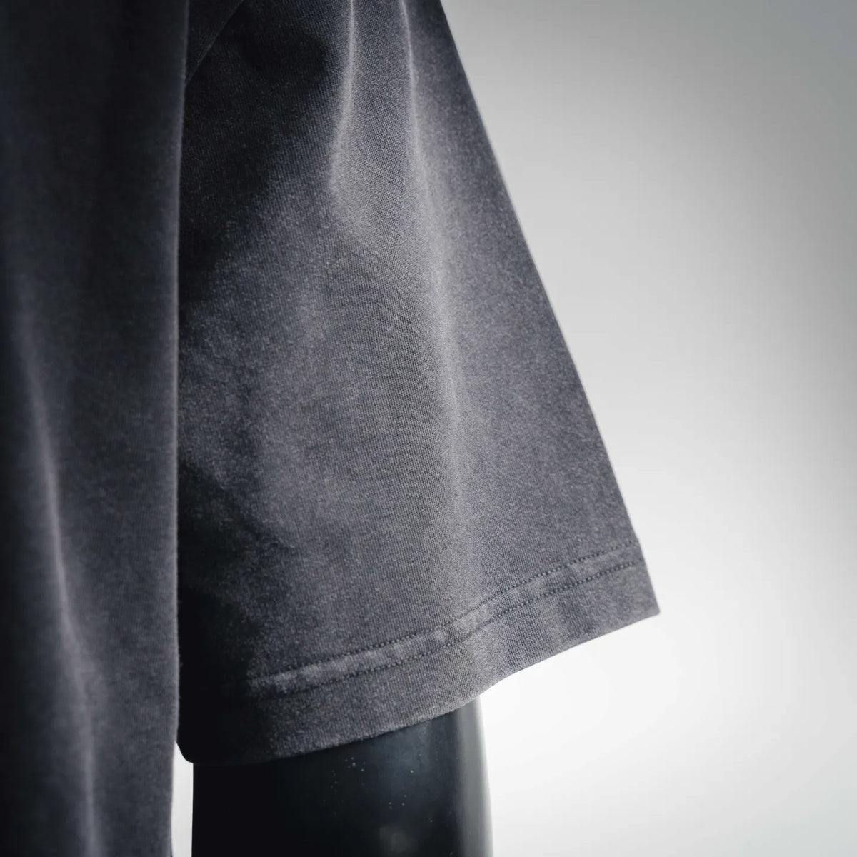 Dark charcoal t-shirt short sleeve with side seam and hem finish.