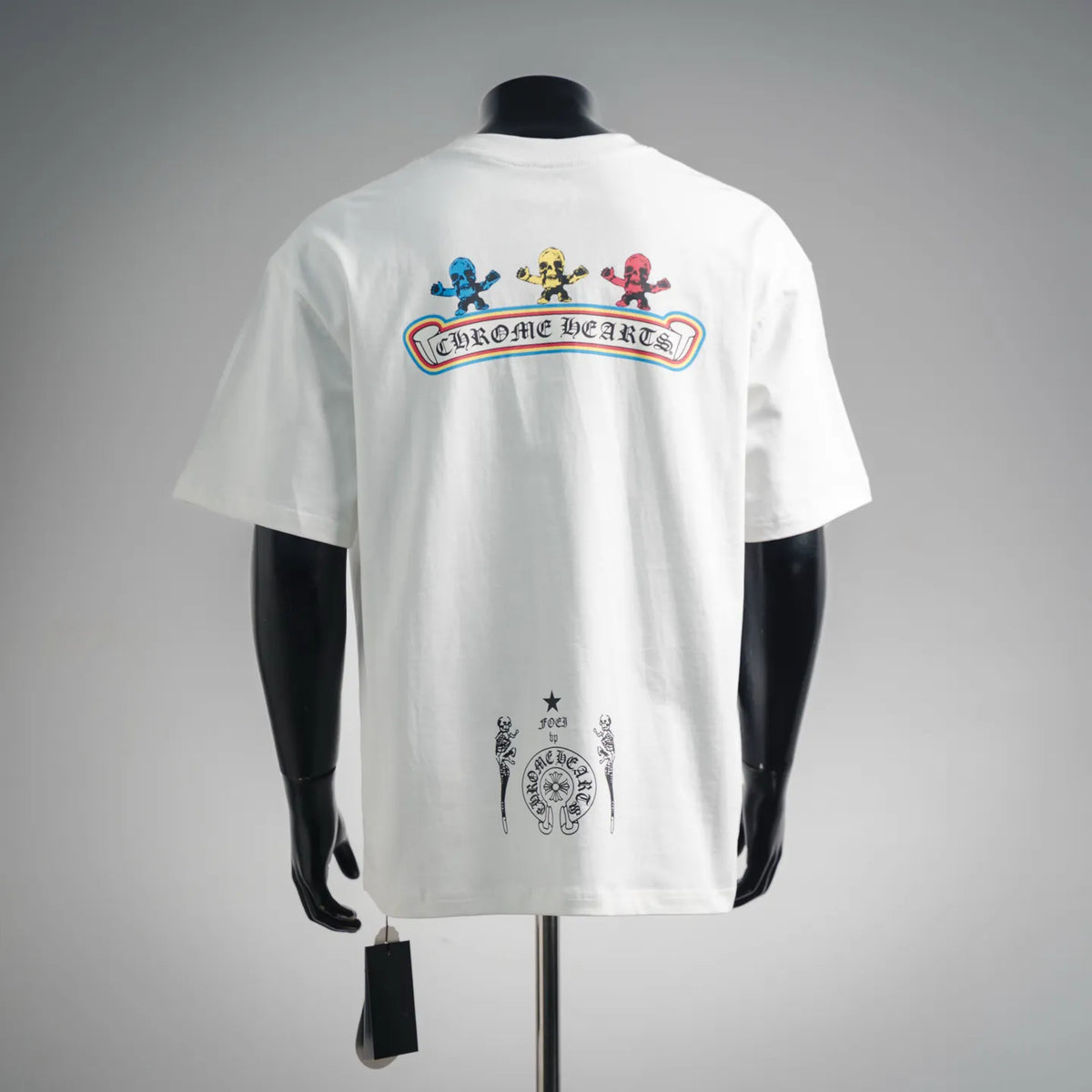 White graphic T-shirt showing back text banner and small central emblem