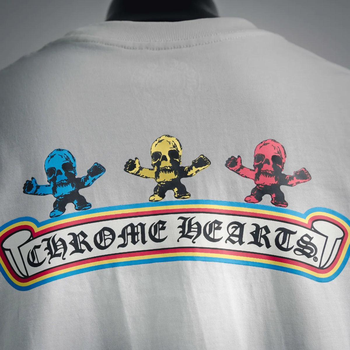 Back graphic T-shirt with rainbow stripe banner and three colored skulls