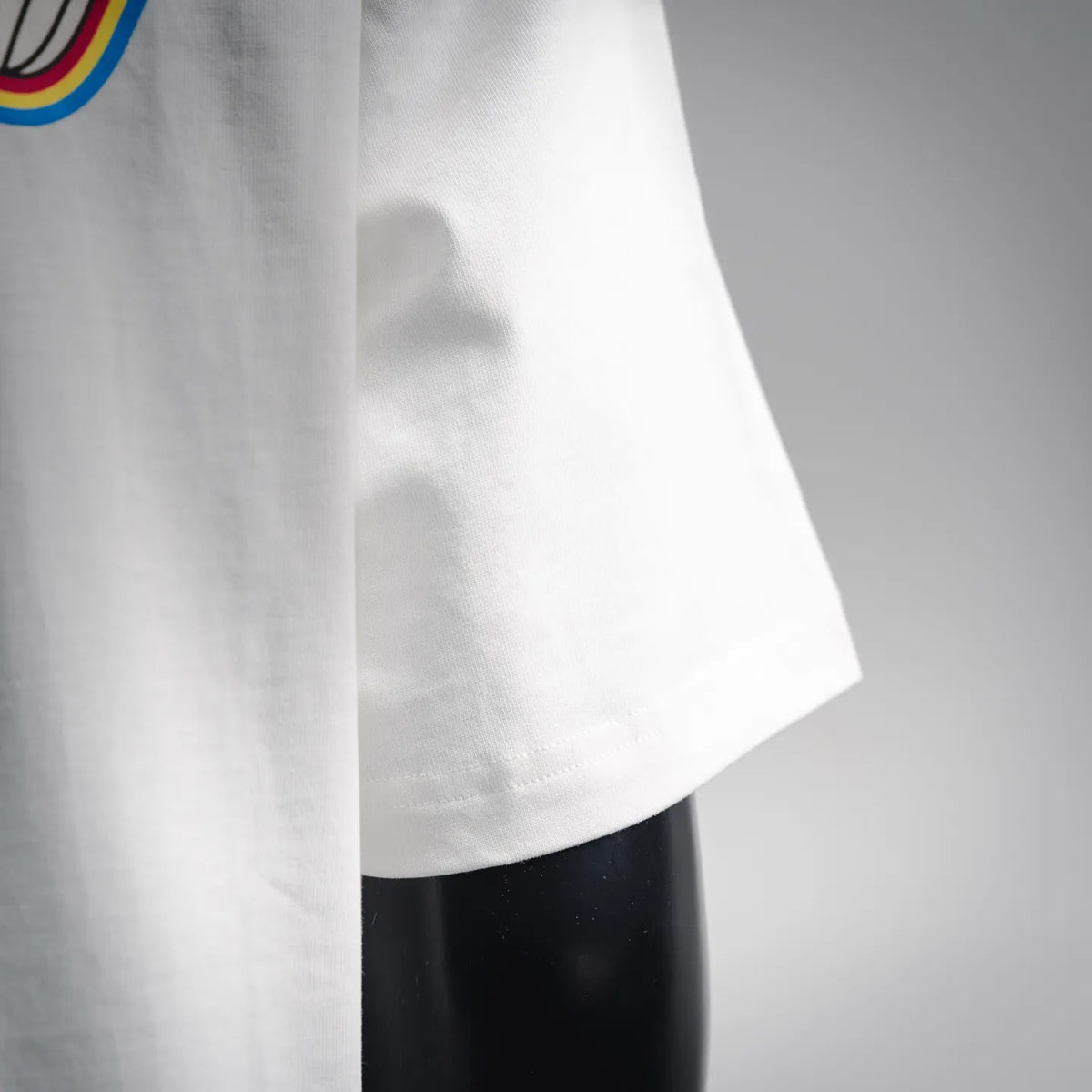 White T-shirt side view with short sleeve hem and smooth fabric drape