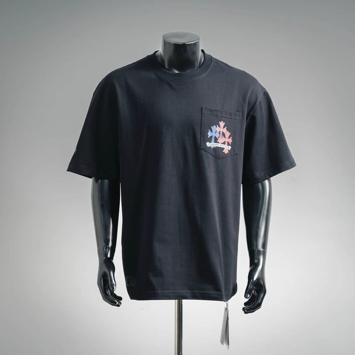 Black crewneck T-shirt with small multicolor flower logo on left chest