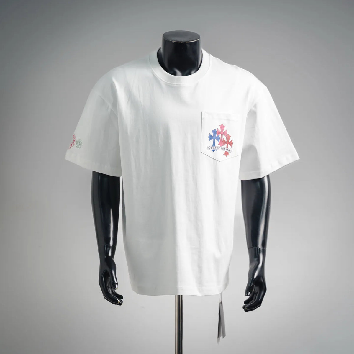 White short-sleeve T-shirt with small front pocket graphic in multicolor flowers.