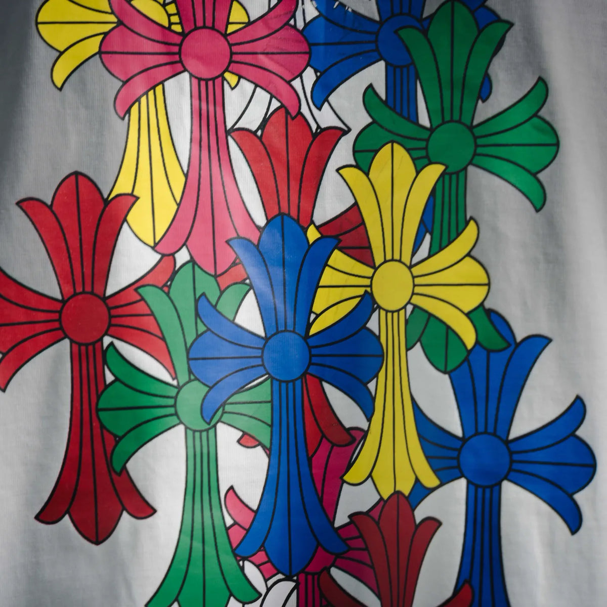 Close-up of multicolor flower graphic on white short-sleeve T-shirt.