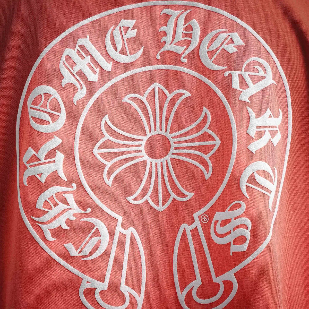 Coral pink T-shirt fabric with large white circular back graphic emblem print