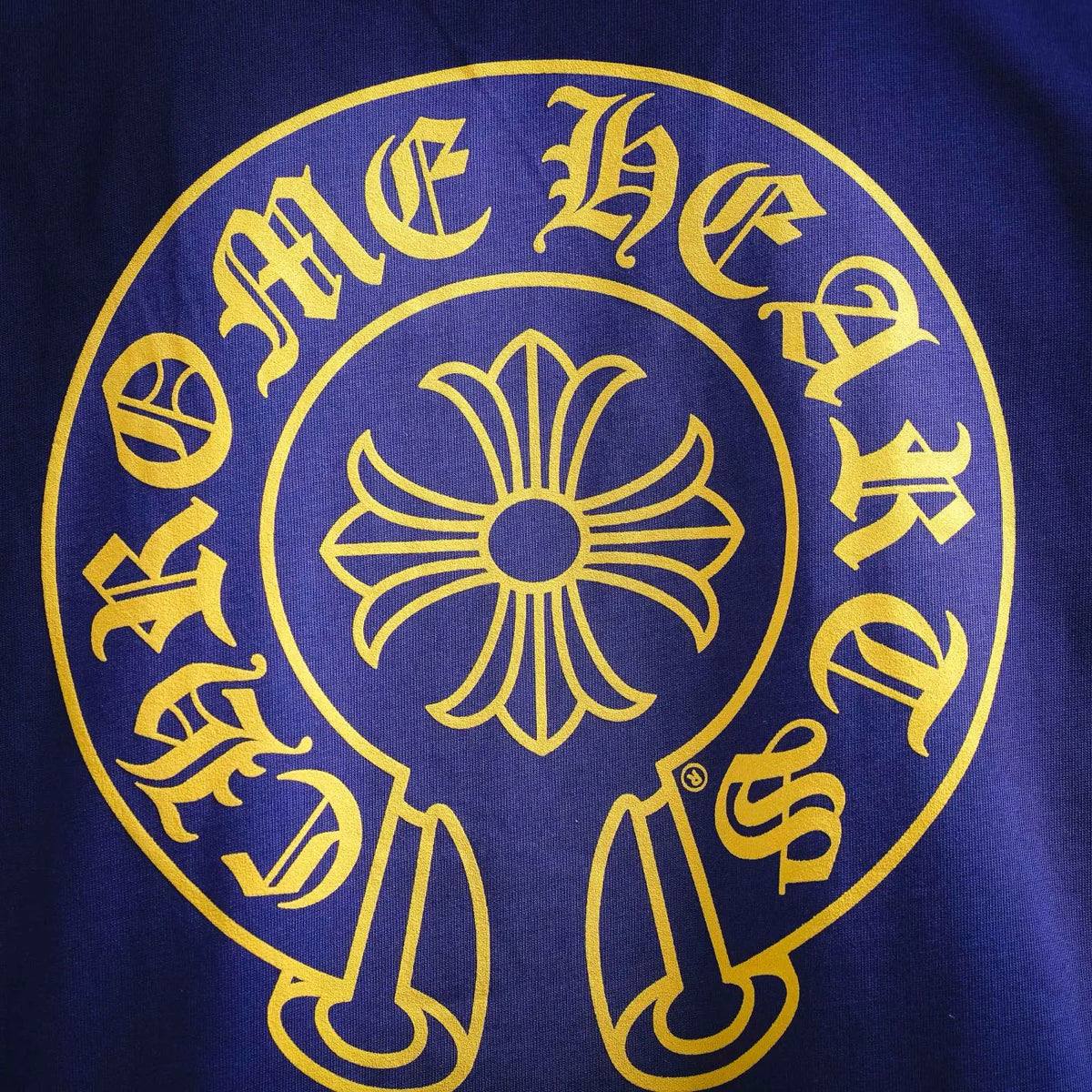 Royal blue T-shirt with large yellow circular back emblem graphic.
