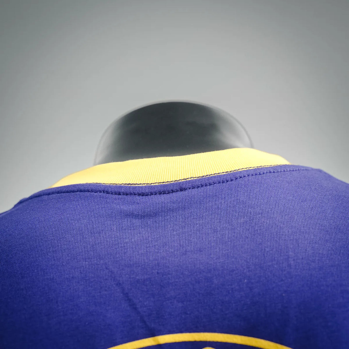Royal blue T-shirt showing yellow ribbed collar on black mannequin.