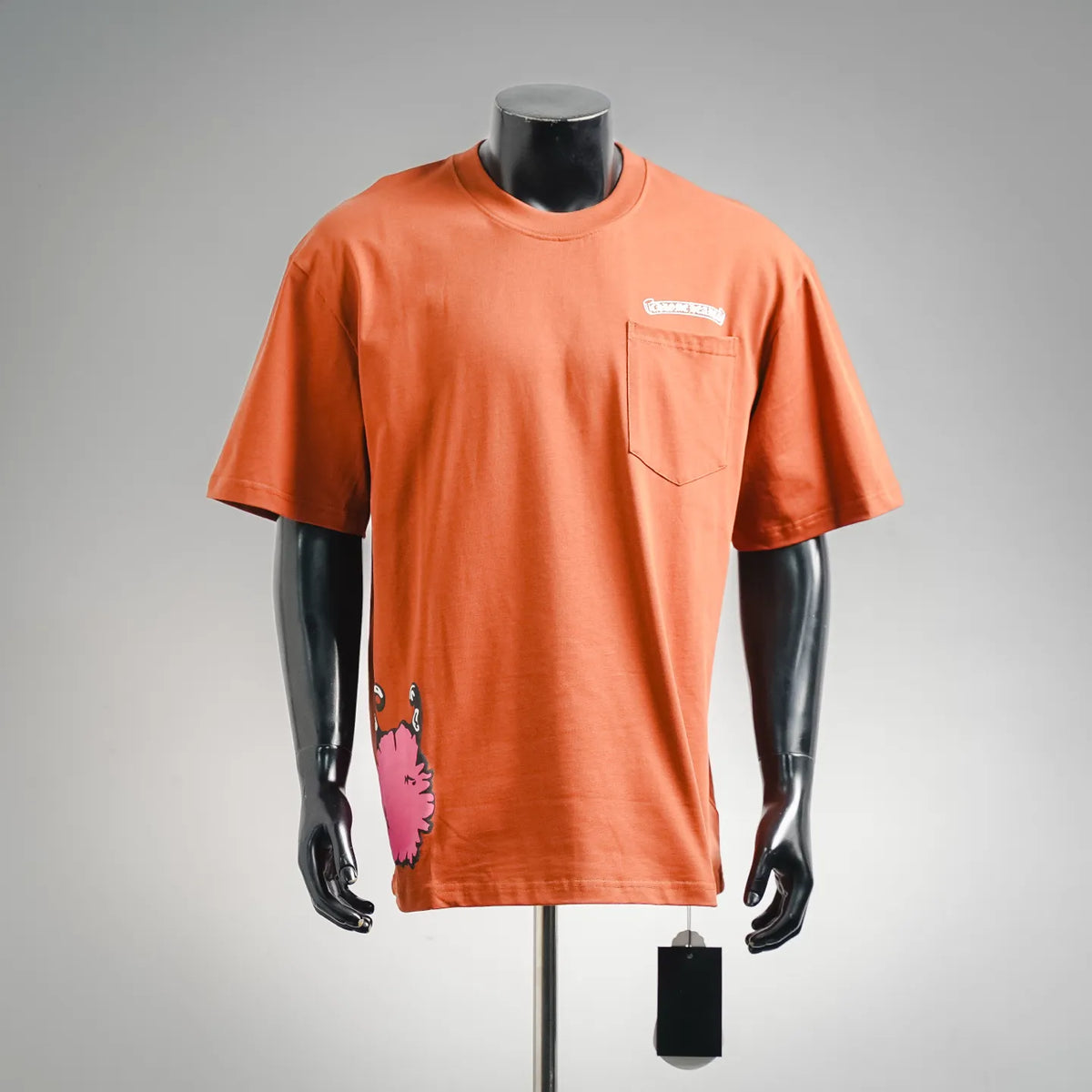 Orange short-sleeve crewneck T-shirt with chest pocket and small graphic on front