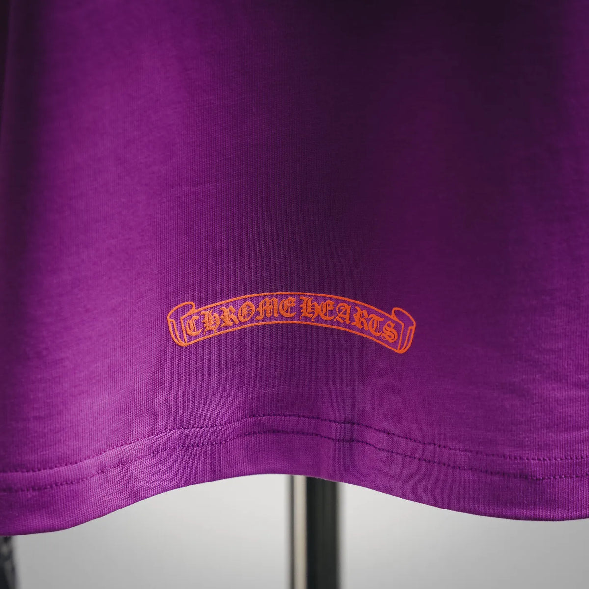 Purple T-shirt chest logo embroidery in gold and black