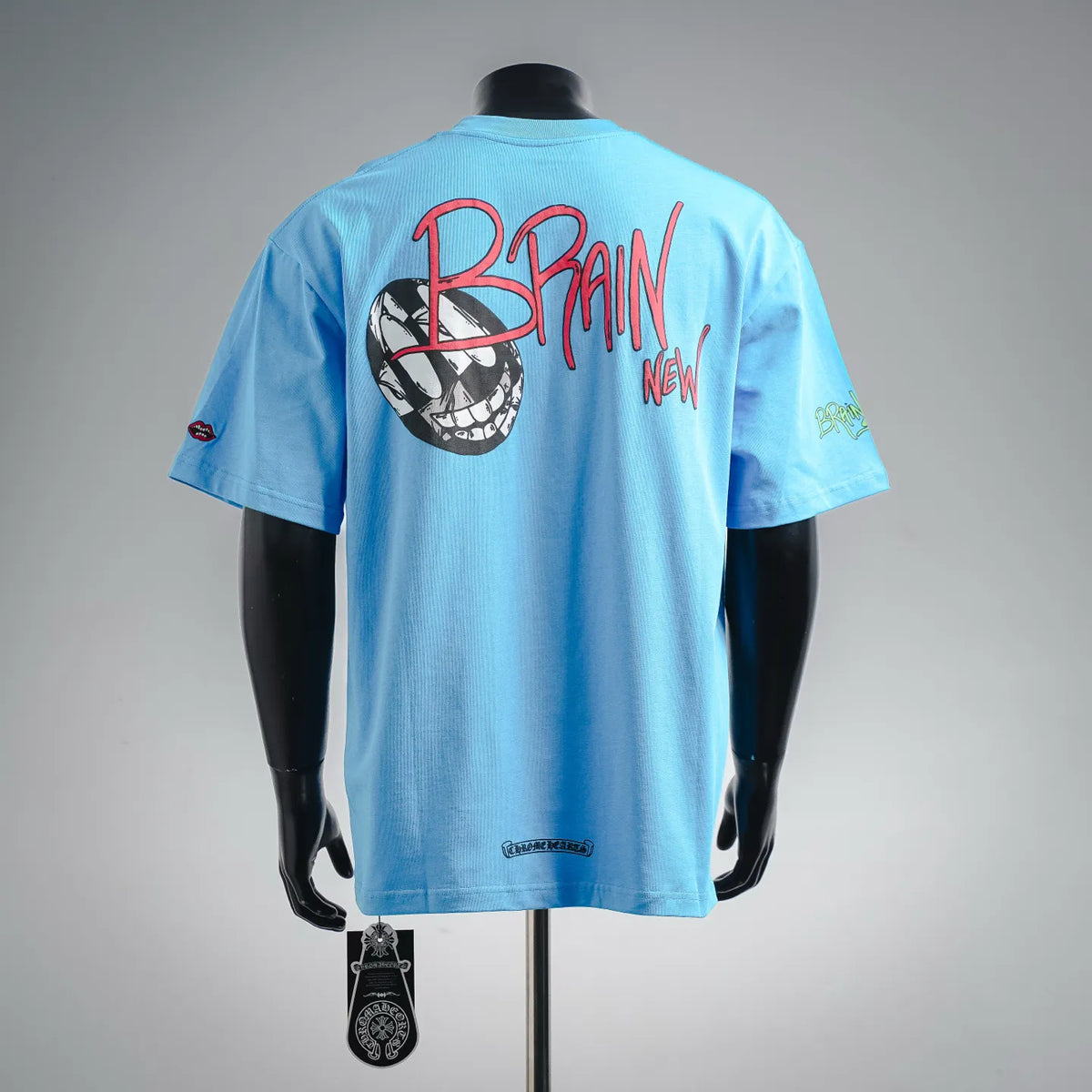 Light blue T-shirt back with large red-and-black character graphic