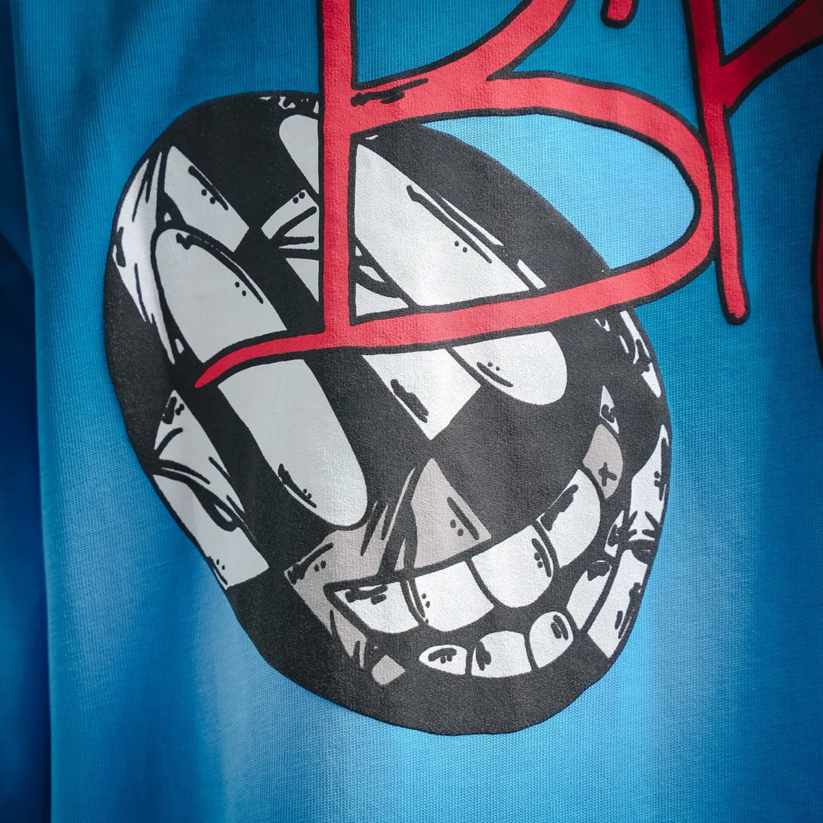 Close-up of light blue T-shirt front with black-and-white heart graphic