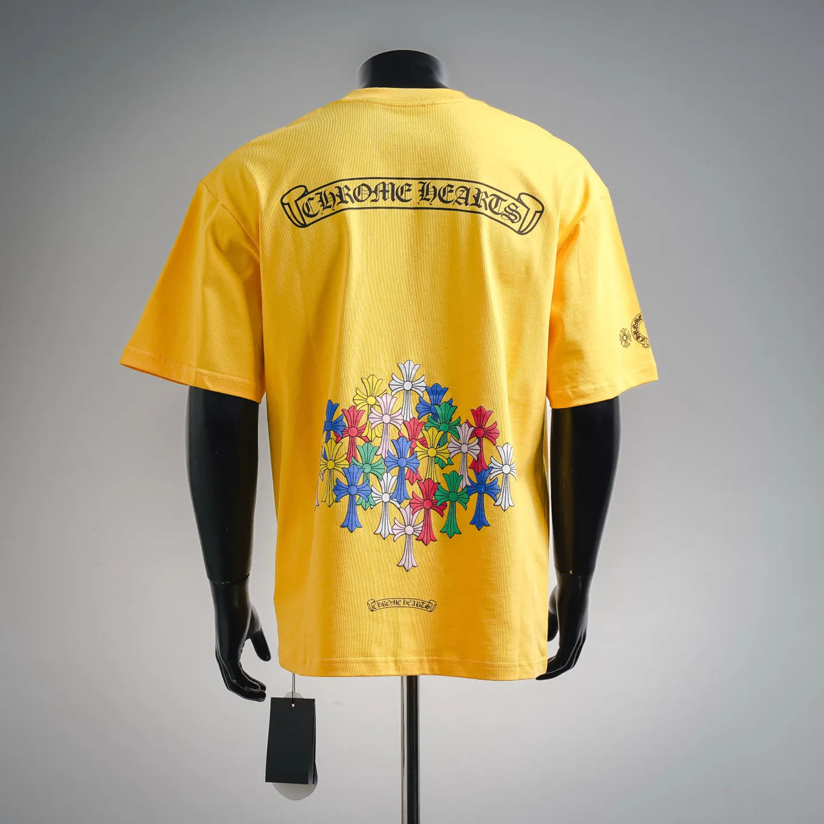 Yellow back of short-sleeve T-shirt with large floral graphic and logo text