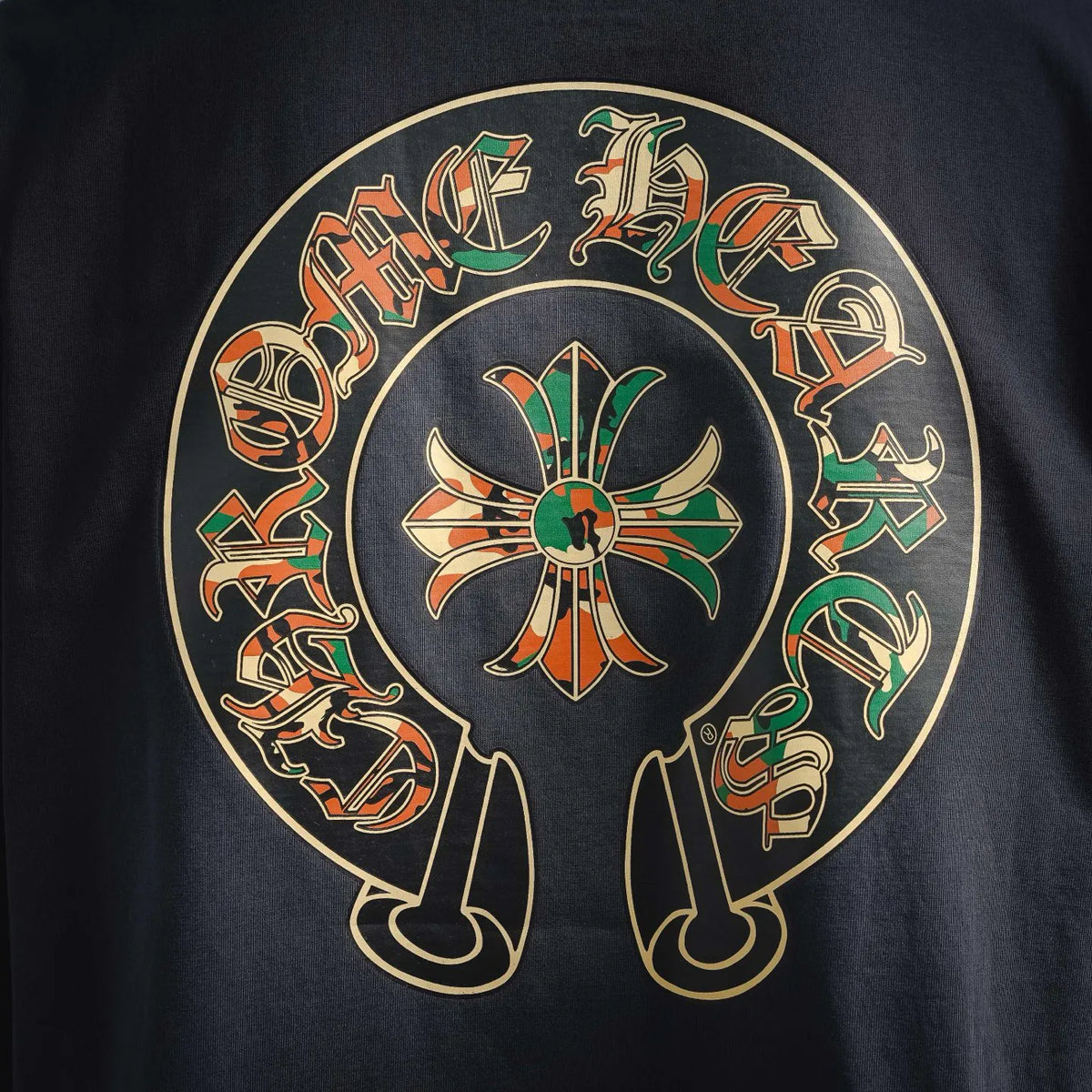 Close-up of dark navy circular back graphic with multicolor characters and symbols