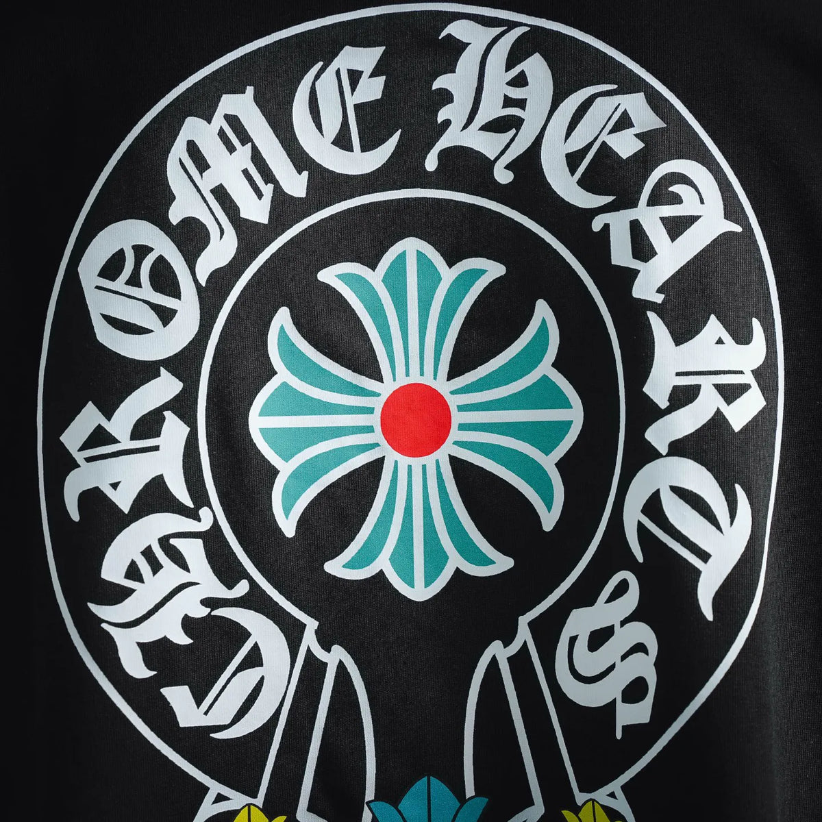 Close-up of large back circular floral graphic with white lettering and blue flower
