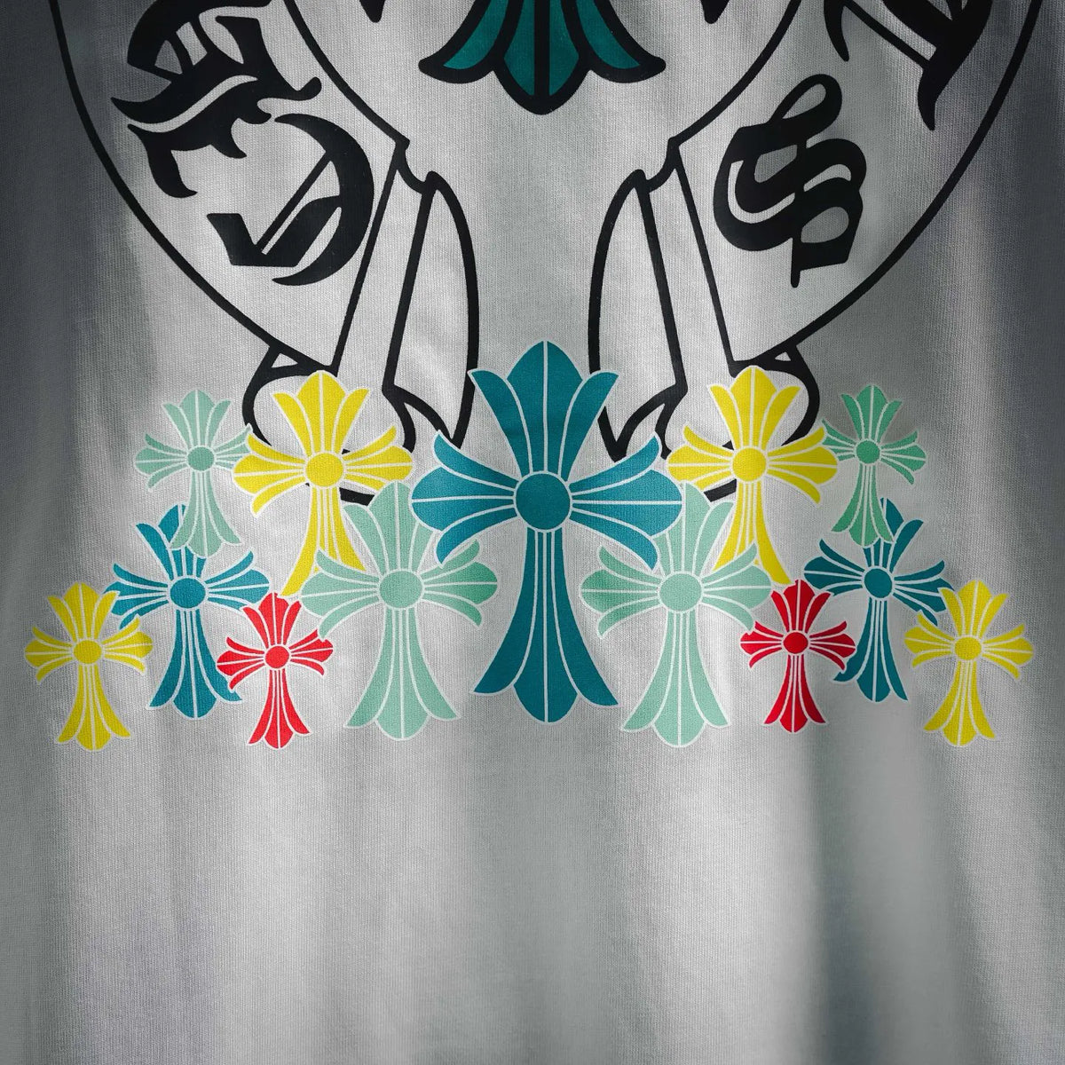 Close-up of white T-shirt chest graphic with colorful flower design