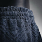 Close-up of dark navy shorts waistband and textured front pattern