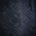 Detailed view of dark navy textured fabric pattern on shorts