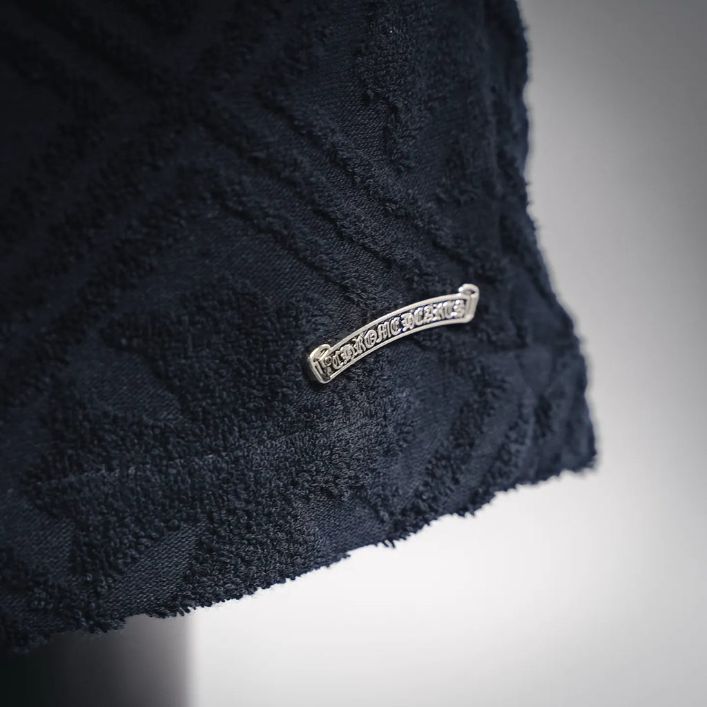Side hem of dark navy textured shorts with small silver label