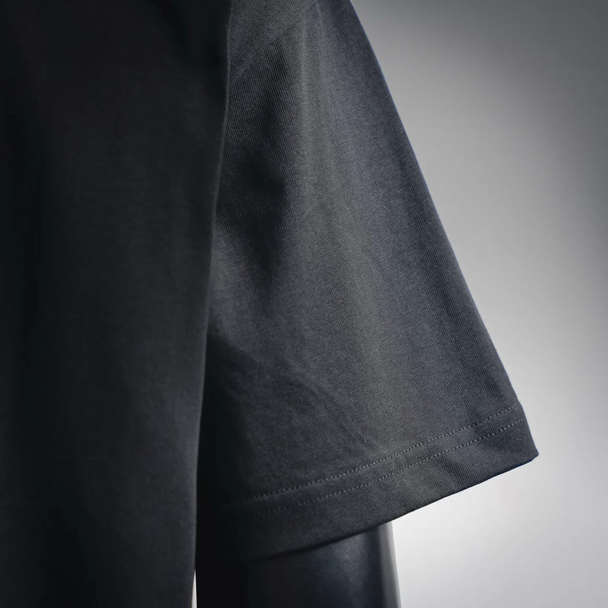 Black short-sleeve T-shirt sleeve with stitched hem detail