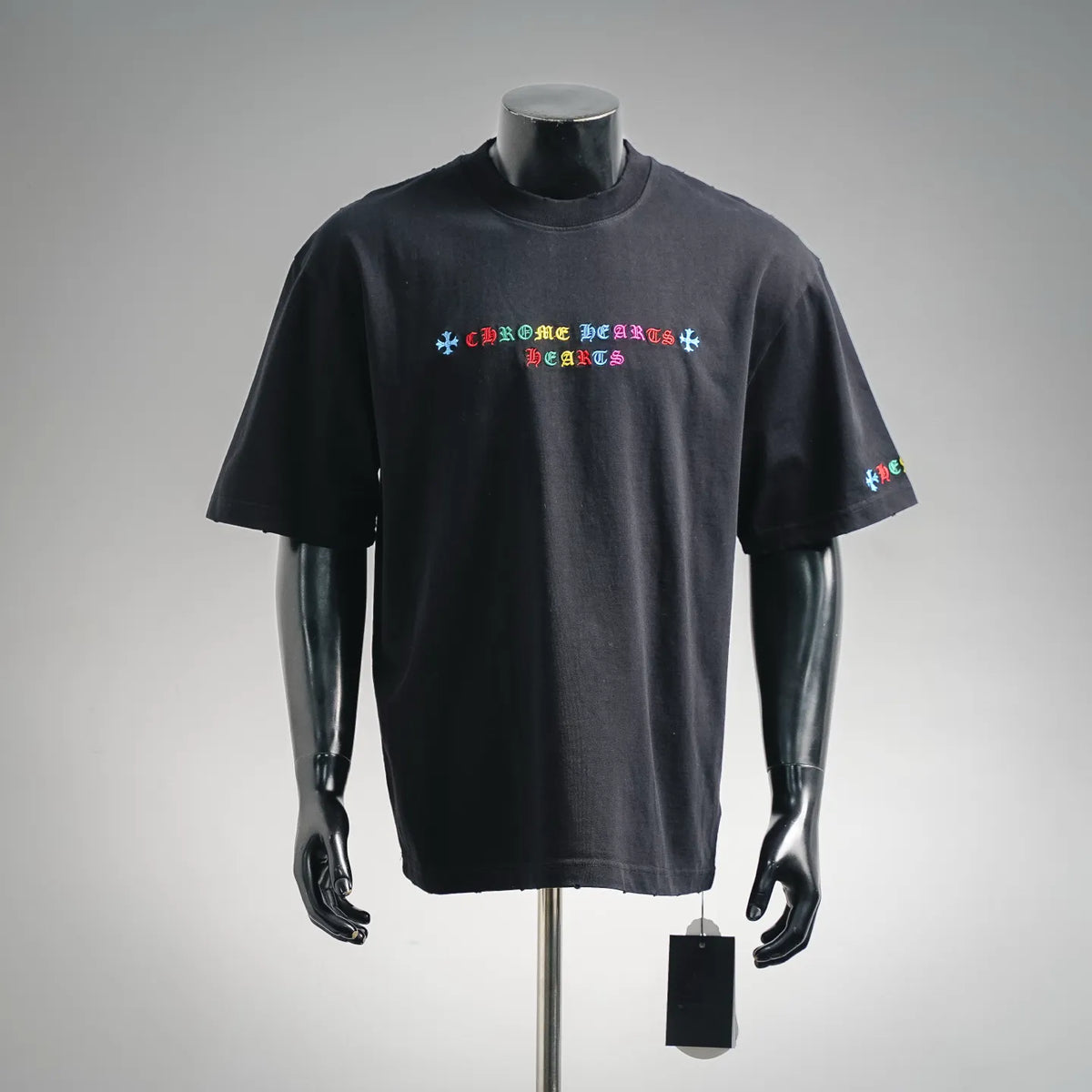 Black short-sleeve T-shirt with small multicolor graphic logo on the chest.