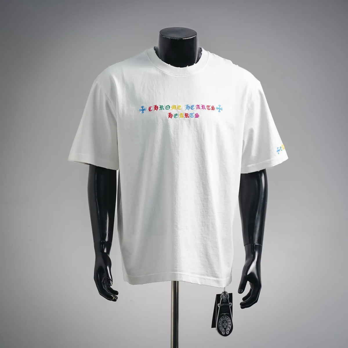 White short-sleeve graphic T-shirt with colorful text design at chest