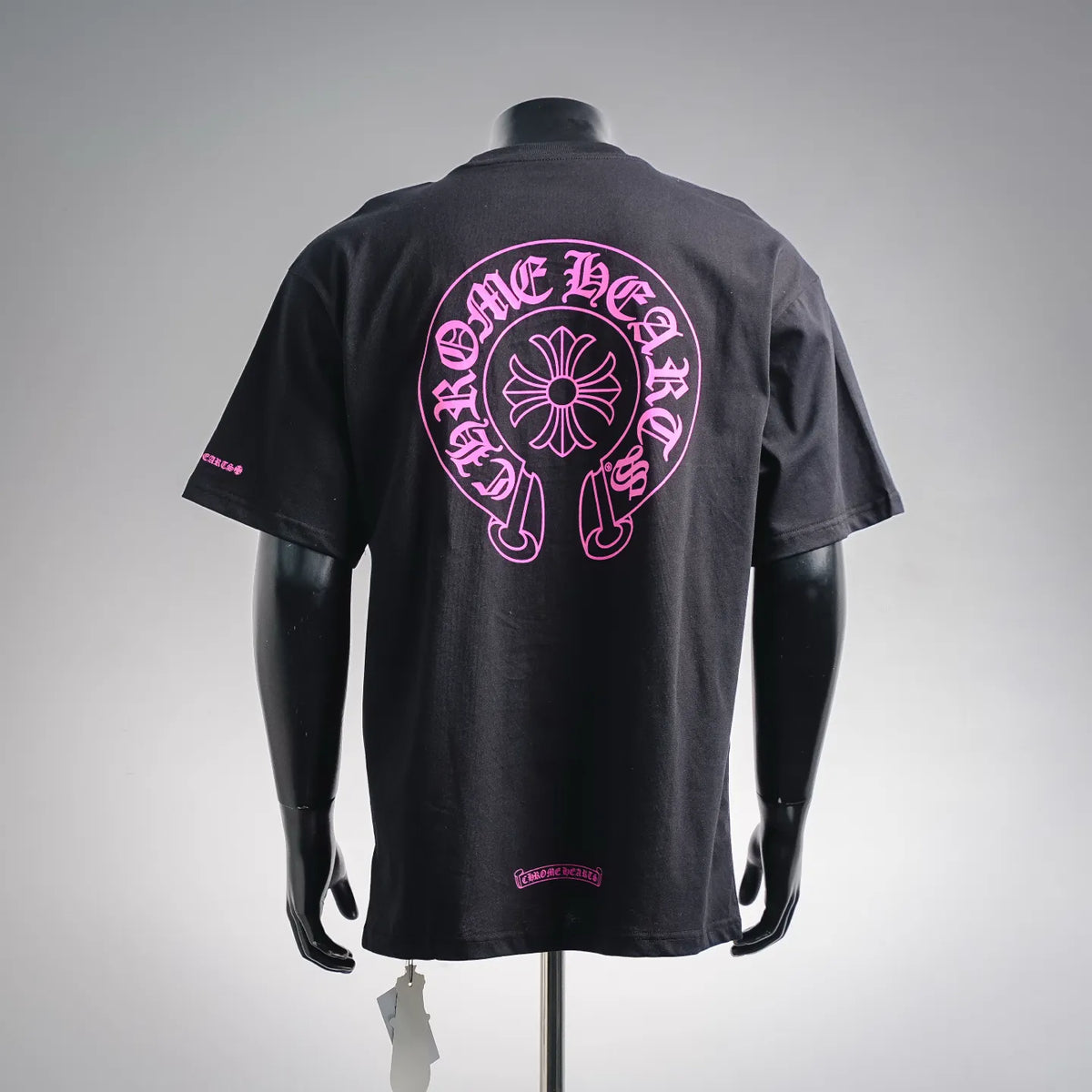 Black short-sleeve T-shirt with large pink back logo graphic and small hem label