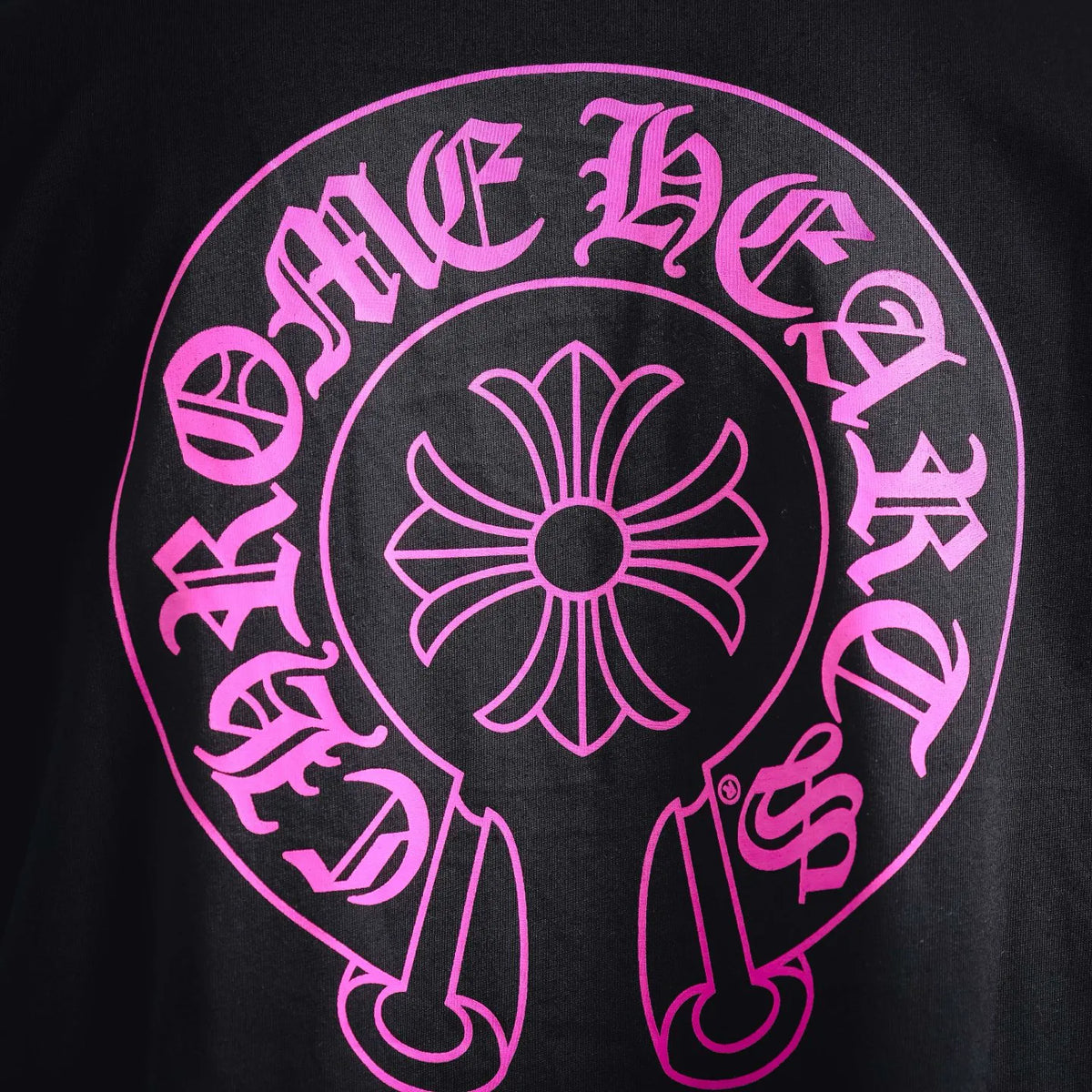 Pink skull-and-flower style graphic print on black T-shirt
