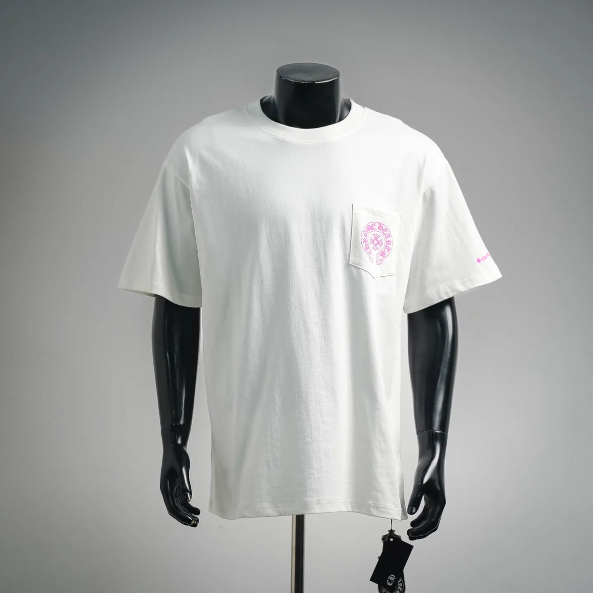 White short-sleeve T-shirt with pink logo graphic on left chest pocket