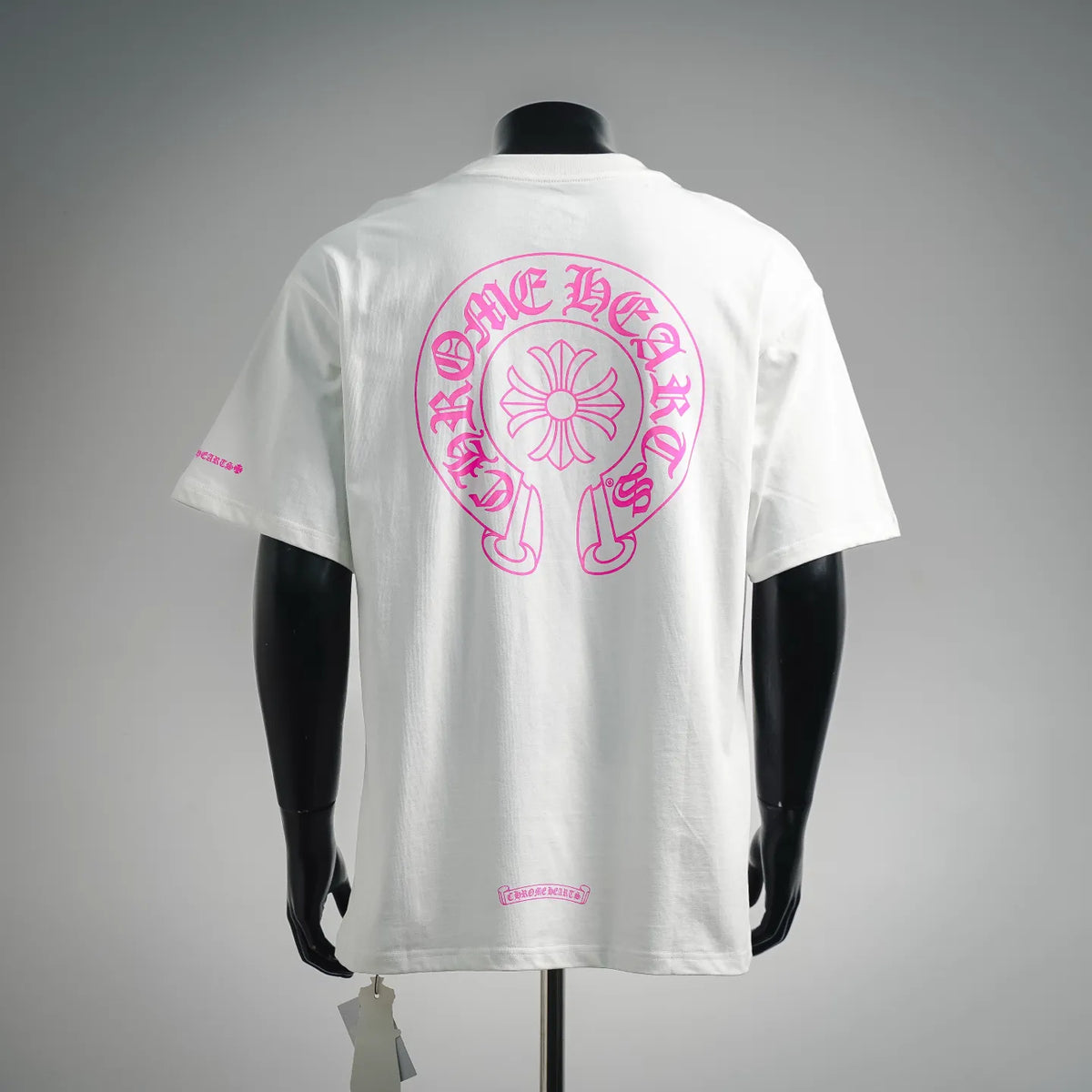 White short-sleeve T-shirt with large pink back graphic and small chest tag