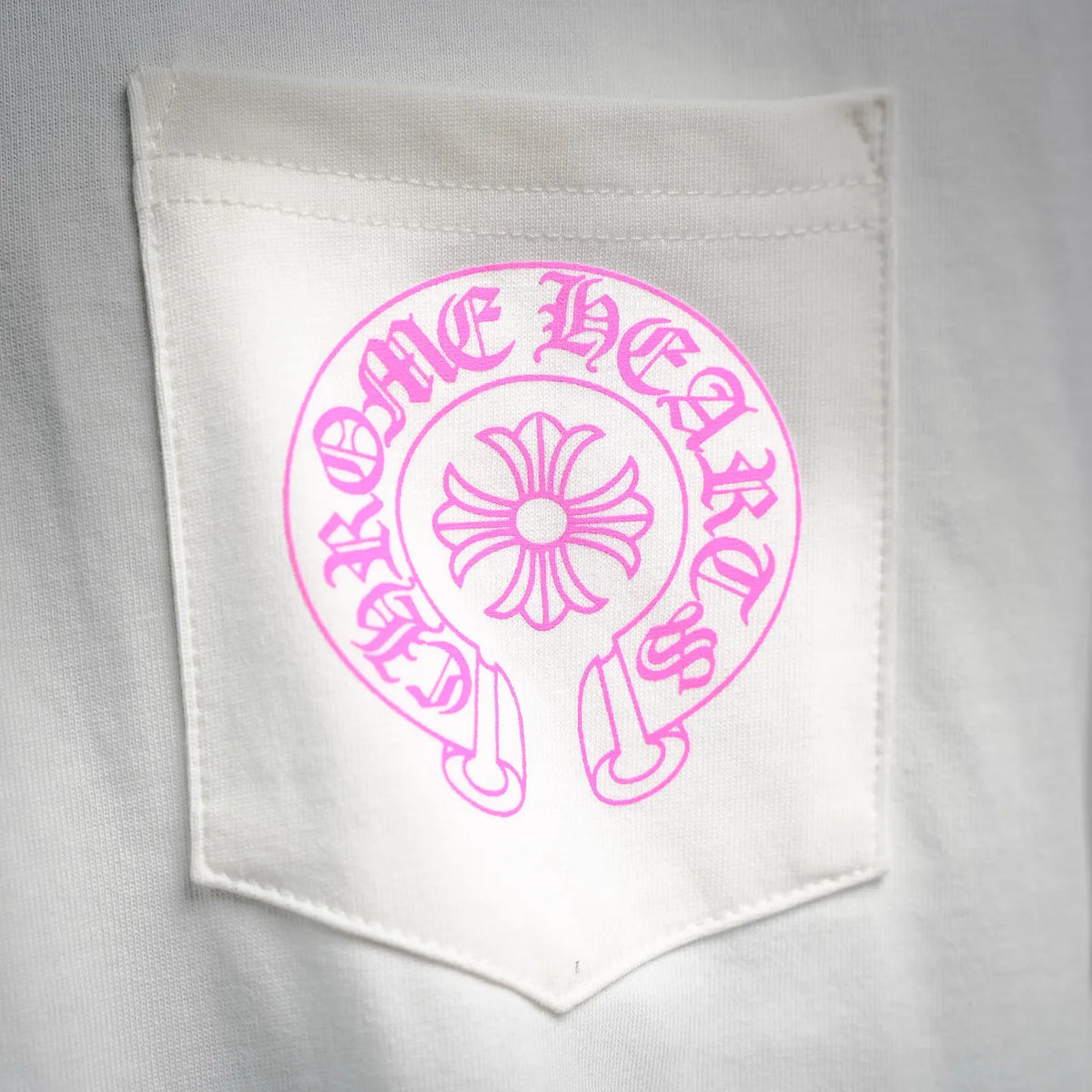 White T-shirt chest pocket with pink logo patch