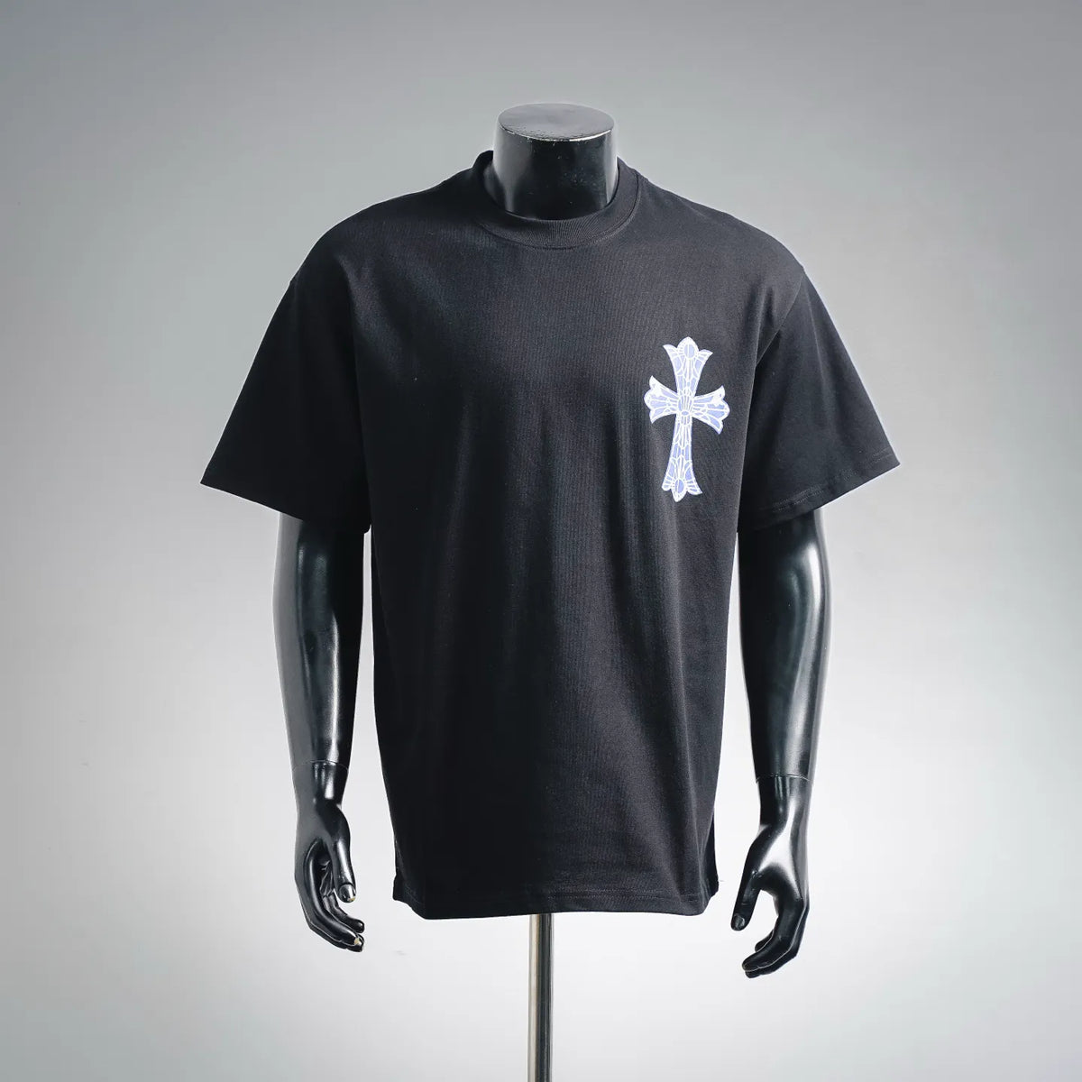 Black crew-neck short-sleeve T-shirt with small blue-and-white cross chest print